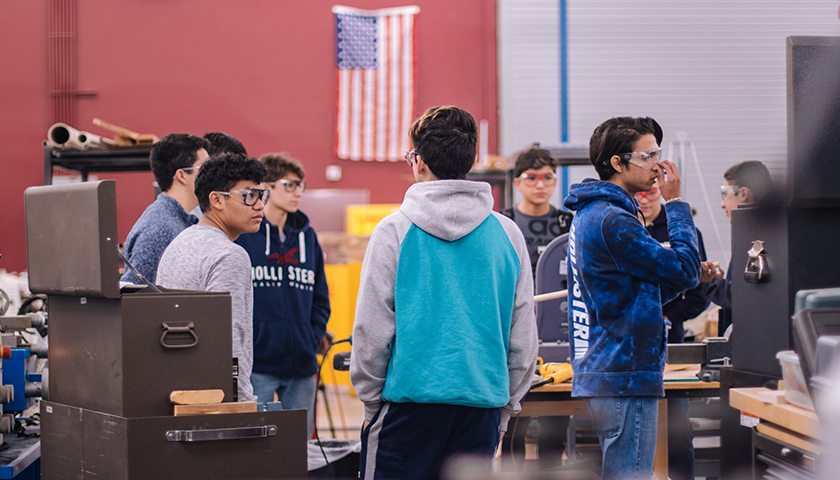 Students in shop class at school with safety goggles on